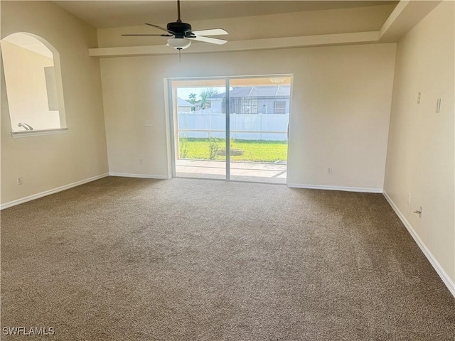 carpeted spare room featuring ceiling fan