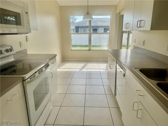 kitchen featuring pendant lighting, white appliances, white cabinetry, and light tile patterned flooring