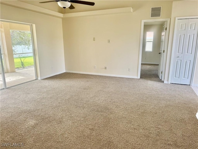 carpeted empty room featuring plenty of natural light and ceiling fan