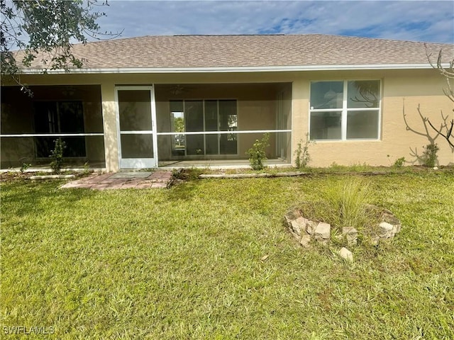 back of house featuring a sunroom and a yard