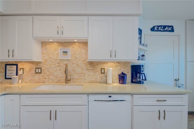 kitchen with decorative backsplash, white dishwasher, white cabinetry, and sink