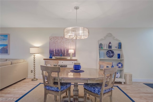 dining room featuring light hardwood / wood-style floors and an inviting chandelier