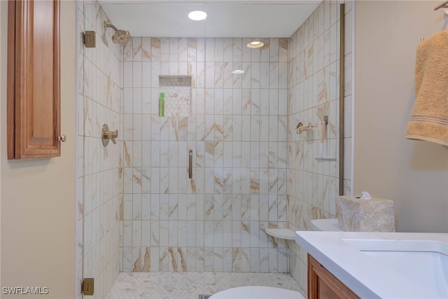 bathroom with toilet, an enclosed shower, and vanity