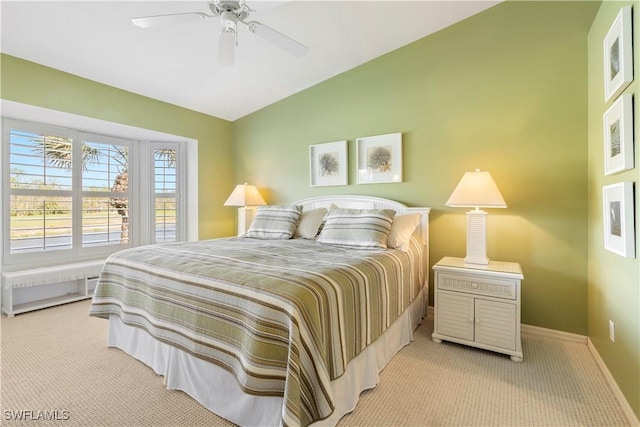 bedroom featuring ceiling fan, light colored carpet, and vaulted ceiling