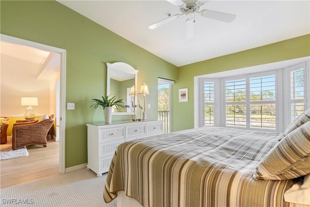 bedroom featuring lofted ceiling, light carpet, and ceiling fan