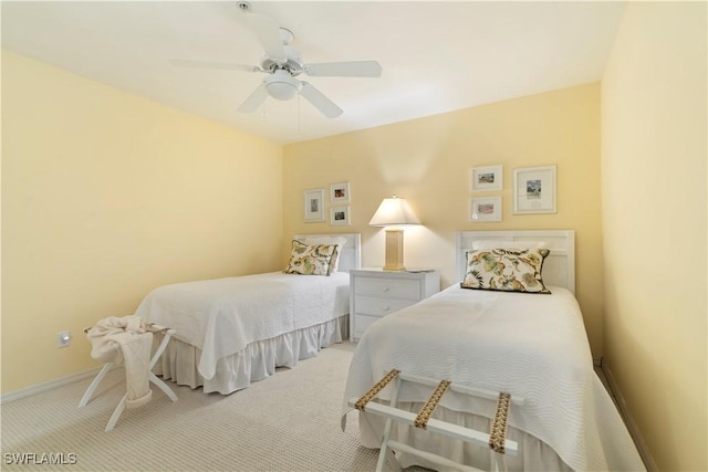 bedroom featuring light colored carpet and ceiling fan