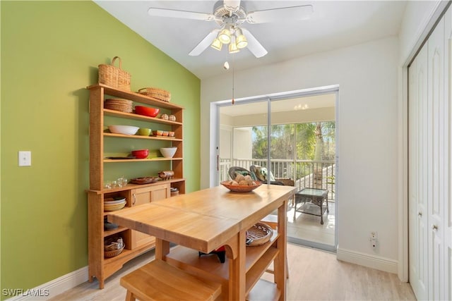 dining space with ceiling fan and light wood-type flooring