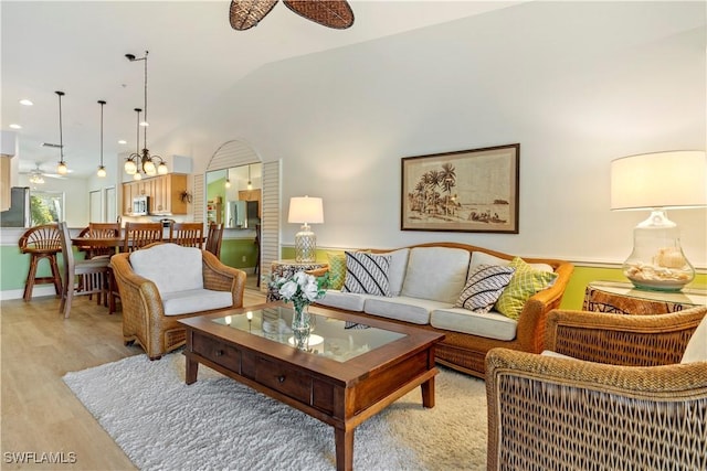 living room featuring ceiling fan and light hardwood / wood-style flooring