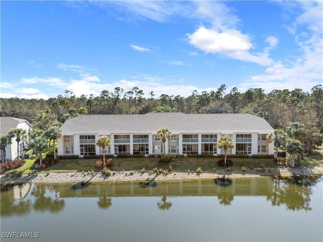 rear view of property with a water view