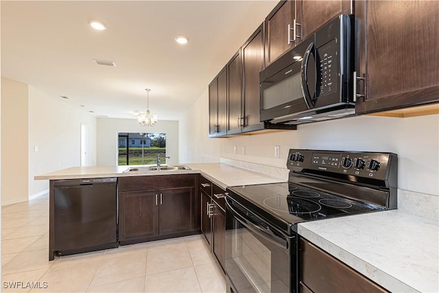 kitchen featuring kitchen peninsula, sink, black appliances, pendant lighting, and a chandelier