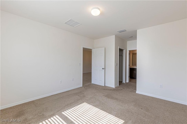 spare room featuring light colored carpet