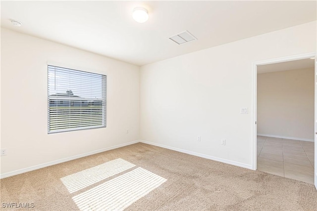 unfurnished room with light colored carpet