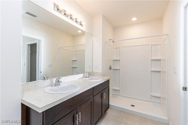 bathroom featuring tile patterned floors, vanity, and walk in shower