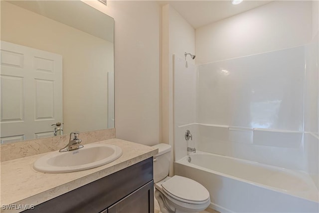 full bathroom featuring toilet, vanity, and tub / shower combination