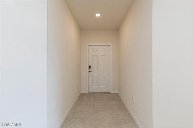 hall with light tile patterned floors