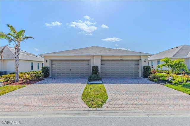 single story home with central AC and a garage