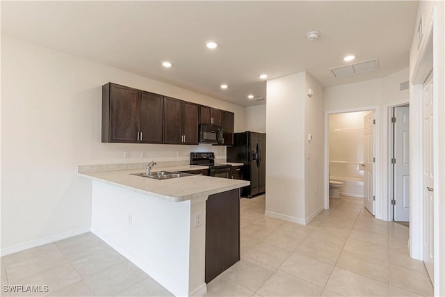 kitchen featuring kitchen peninsula, dark brown cabinetry, sink, black appliances, and light tile patterned flooring