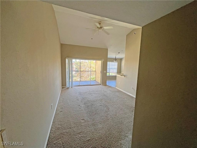 empty room with carpet flooring, ceiling fan, and vaulted ceiling