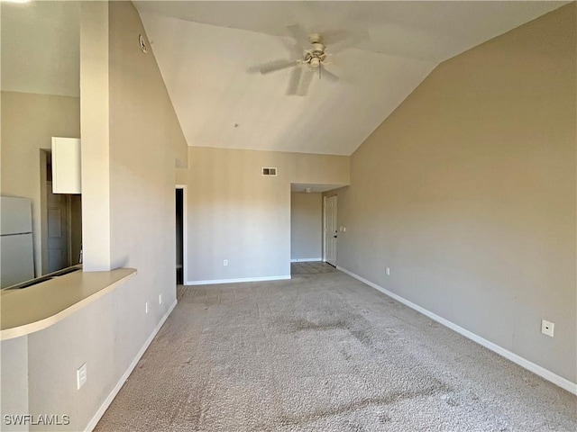 carpeted empty room featuring high vaulted ceiling and ceiling fan