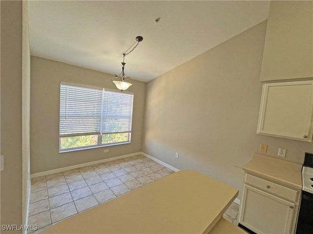 unfurnished dining area featuring light tile patterned floors