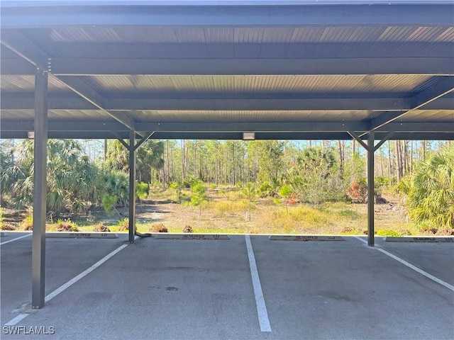 view of parking / parking lot featuring a carport