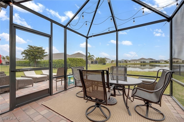 sunroom / solarium with a water view