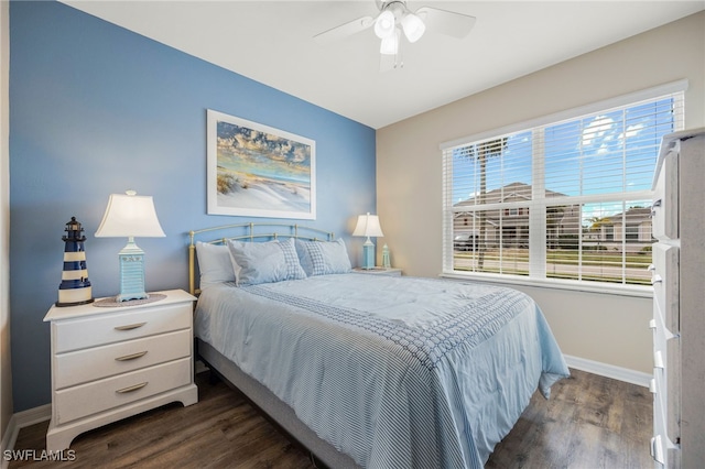 bedroom with ceiling fan and dark wood-type flooring