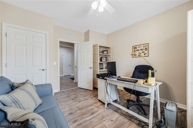 office area with ceiling fan and light hardwood / wood-style flooring