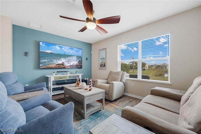 living room featuring hardwood / wood-style flooring and ceiling fan