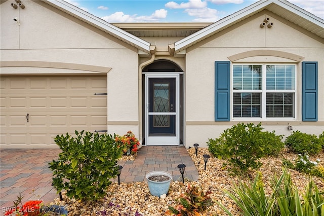 view of exterior entry featuring a garage