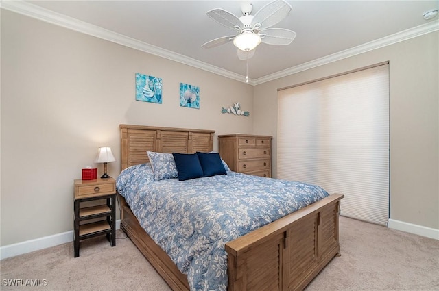 carpeted bedroom featuring ceiling fan and crown molding