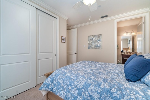 carpeted bedroom featuring a closet, ceiling fan, and crown molding