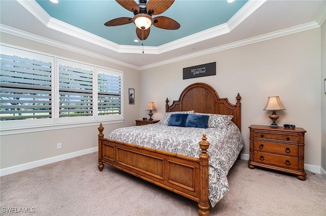 bedroom featuring a tray ceiling, ceiling fan, and crown molding