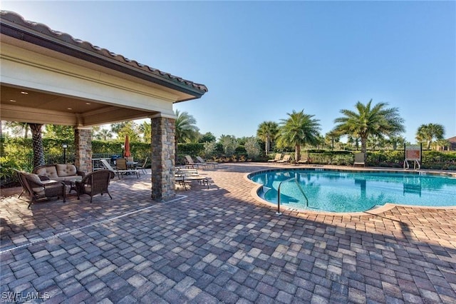 view of swimming pool featuring a patio