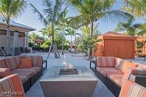 view of patio / terrace featuring an outdoor living space with a fire pit