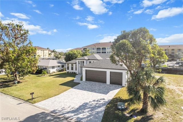 view of front of house with a garage and a front yard