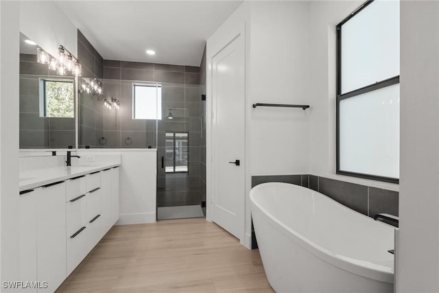 bathroom featuring vanity, separate shower and tub, and tile walls