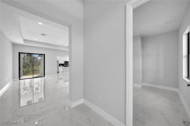 corridor featuring a tray ceiling