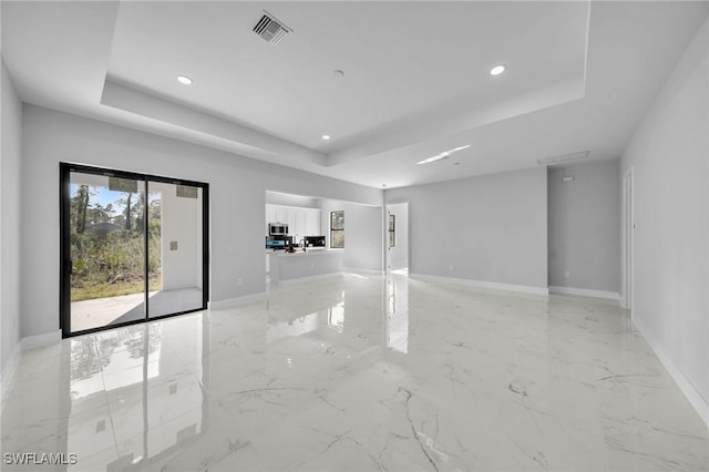 empty room featuring a tray ceiling