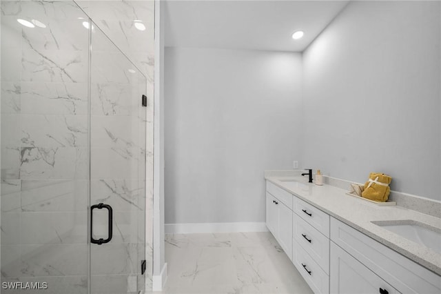 bathroom with vanity and a shower with door