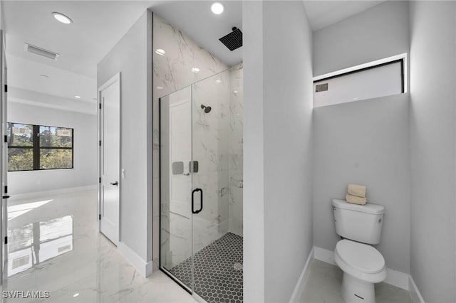 bathroom featuring toilet and an enclosed shower