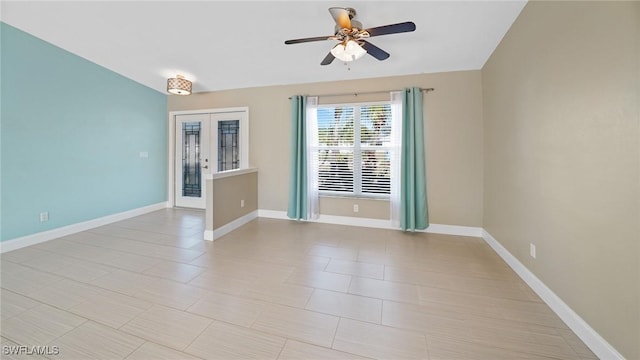 empty room with ceiling fan and french doors