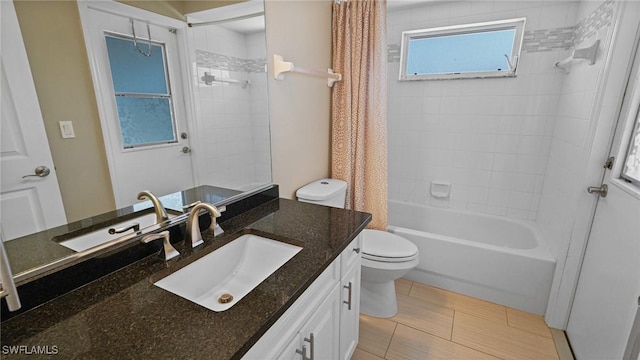 full bathroom featuring toilet, shower / bath combo, and vanity