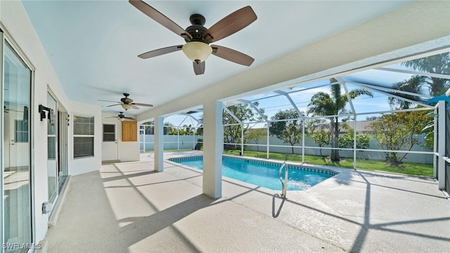 view of swimming pool with a patio and glass enclosure