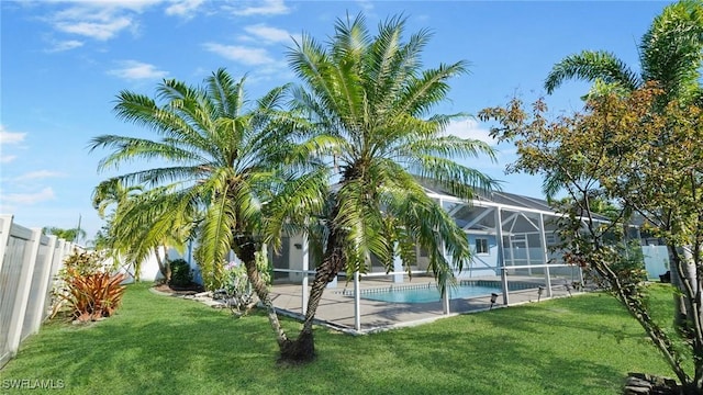 exterior space featuring a swimming pool, a patio area, and a lawn