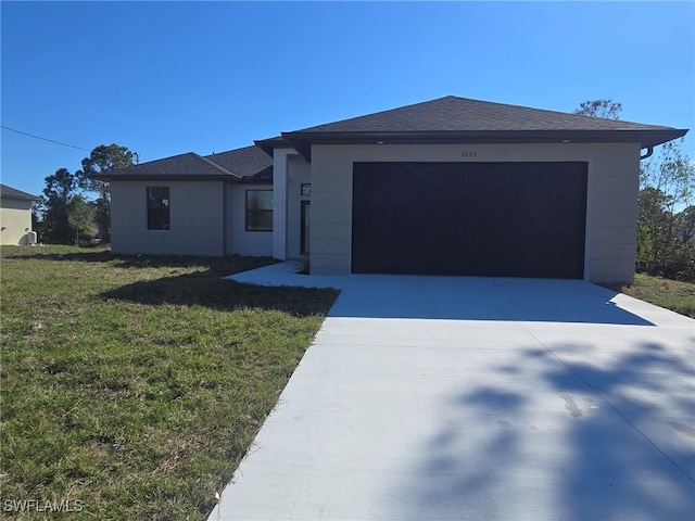 view of front of property featuring a garage and a front yard