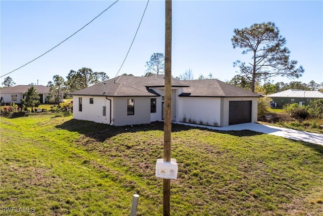 ranch-style house with a garage and a front lawn