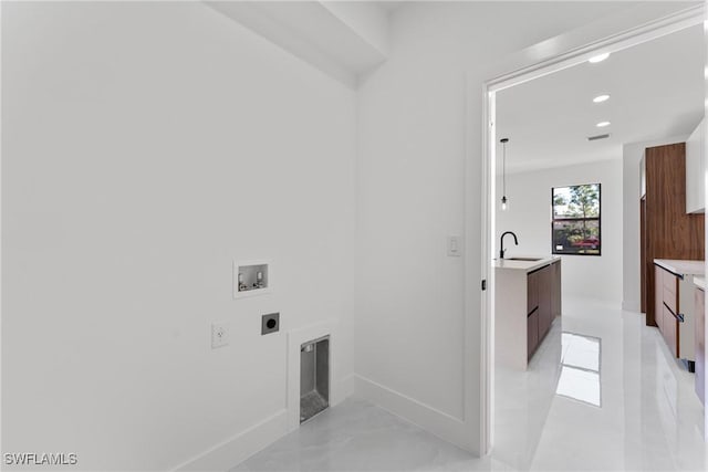 laundry room featuring a fireplace, washer hookup, hookup for an electric dryer, and sink