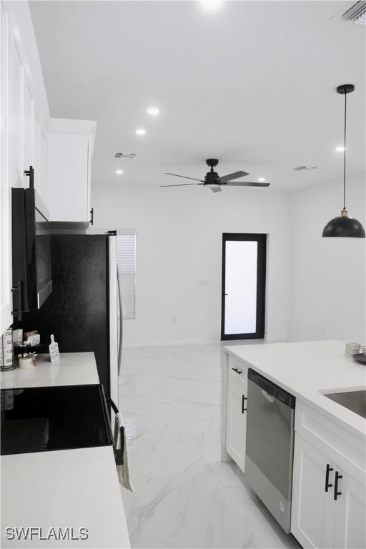 kitchen featuring marble finish floor, stainless steel appliances, recessed lighting, light countertops, and white cabinetry