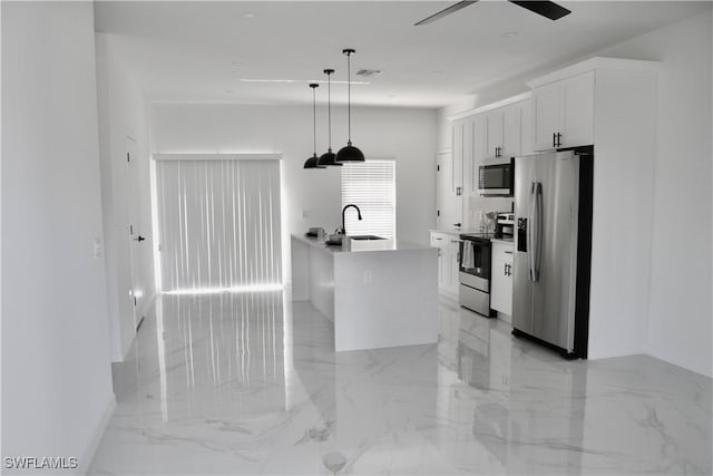 kitchen featuring white cabinets, decorative light fixtures, marble finish floor, stainless steel appliances, and a sink